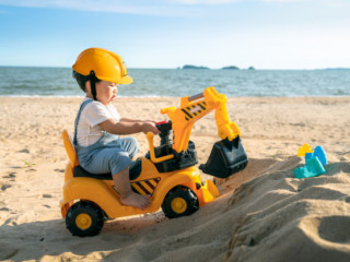 asian-boy-play-excavator-toy-beach_167657-168
